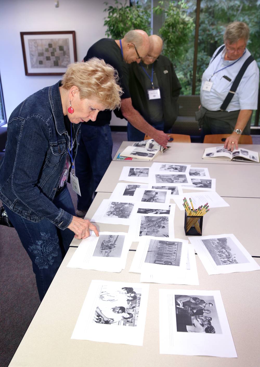 An alumna looking at old photos from 1968.